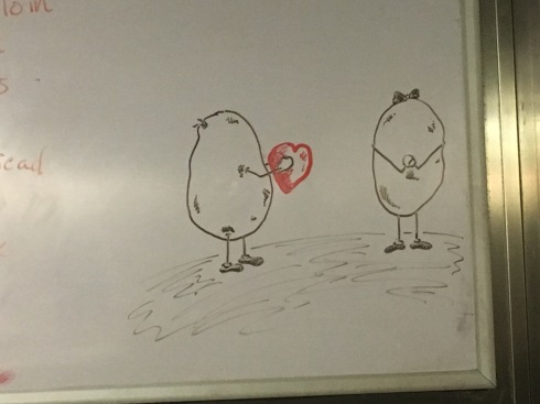 Picture of a male potato handing a heart to a female potato, who is clapping her hands with joy